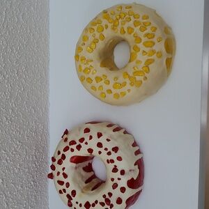 Two donut wall sculptures.